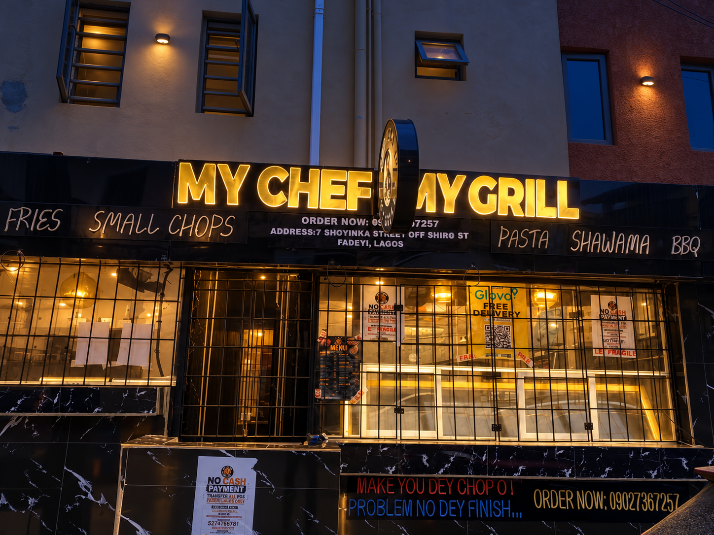 My Chef My Grill storefront with warm lighting after dark